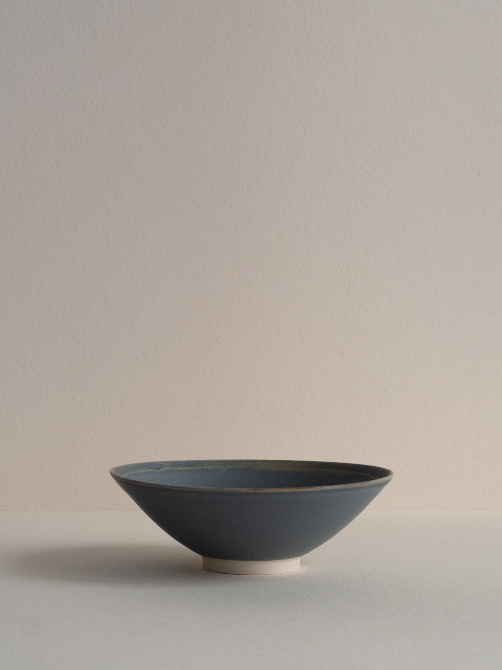Conical stoneware bowl in blue-grey tones