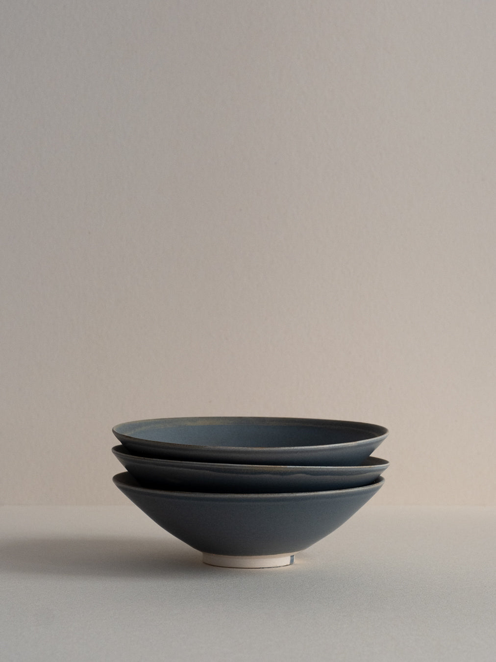 Conical stoneware bowl in blue-grey tones