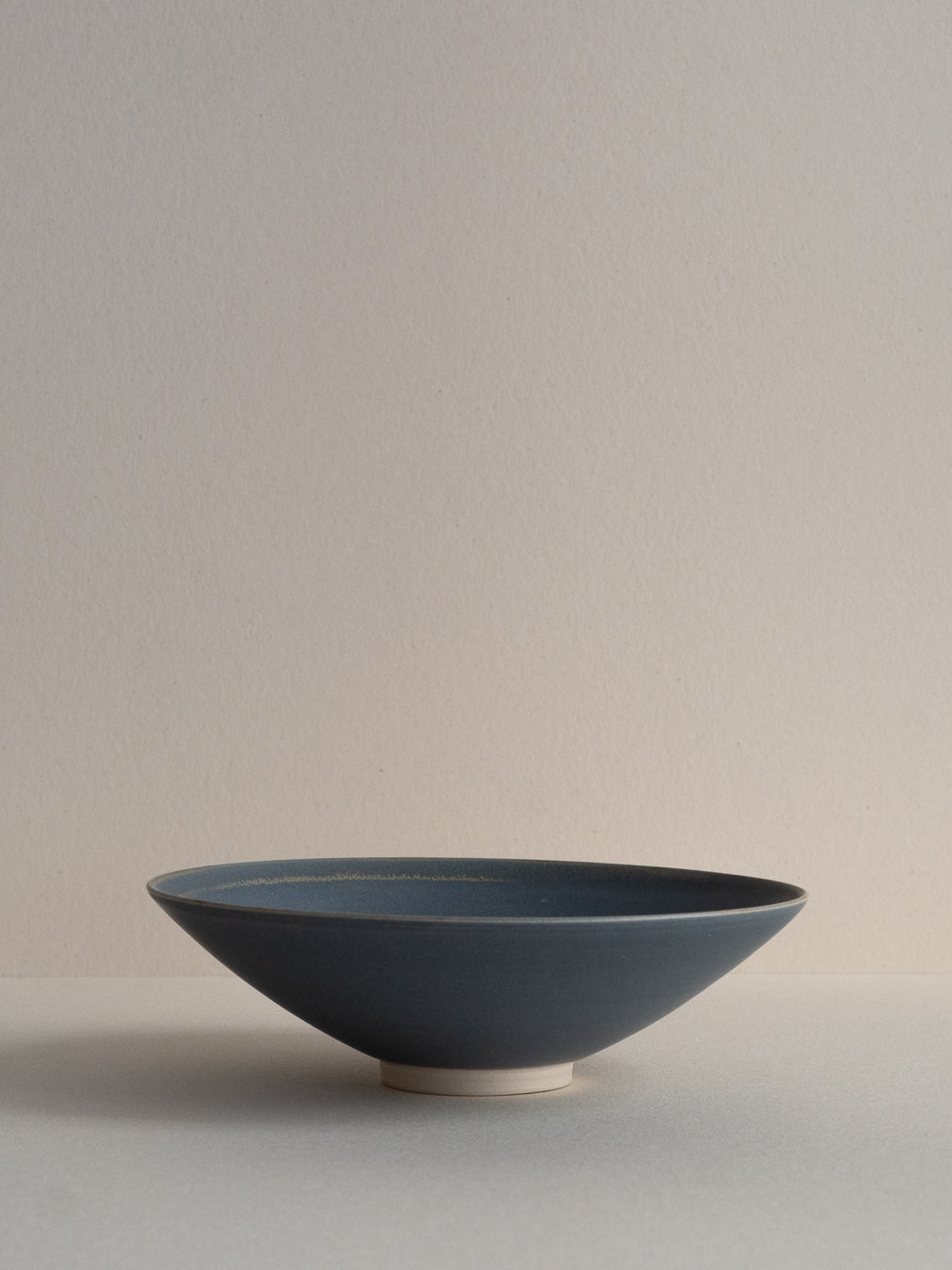 Conical stoneware bowl in blue-grey tones