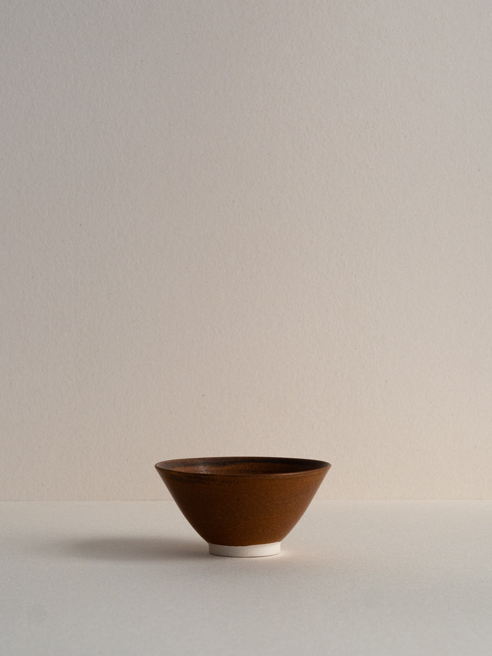 Conical glass in oxidized brown tones