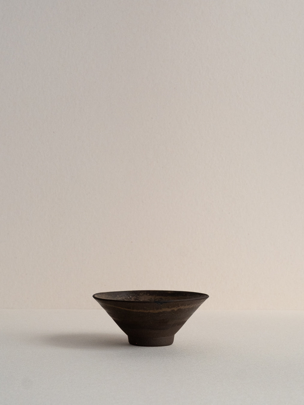 Conic glass finished with a pine ash glaze that creates natural