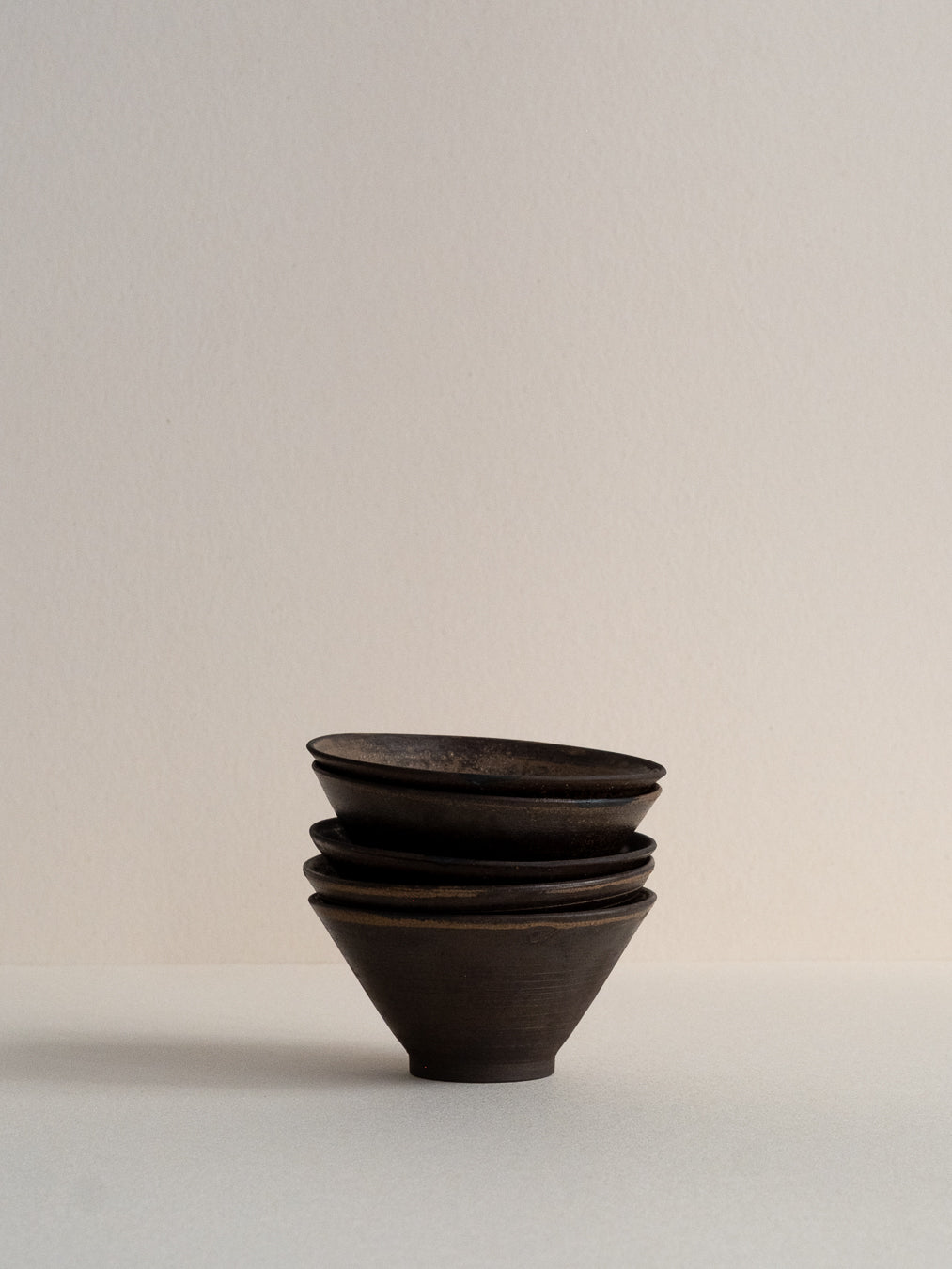 Conic glass finished with a pine ash glaze that creates natural