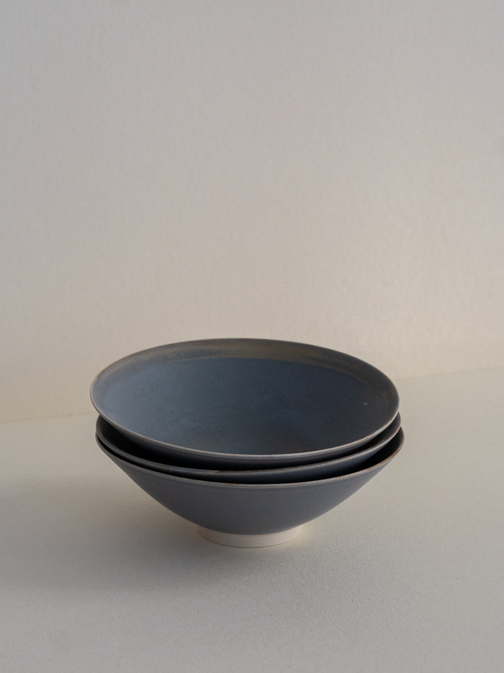 Conical stoneware bowl in blue-grey tones