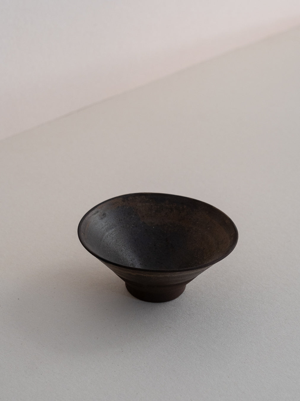 Conic glass finished with a pine ash glaze that creates natural